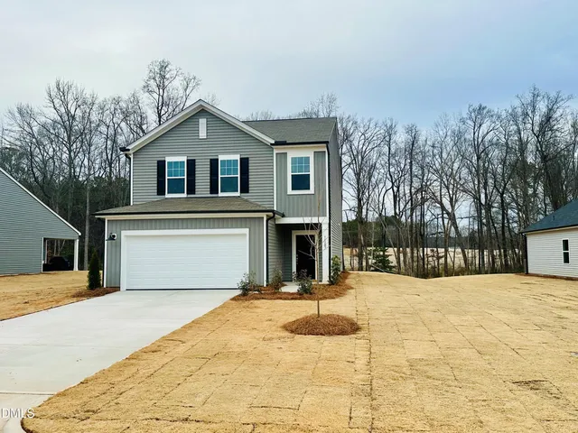a view of a house with snow on the road