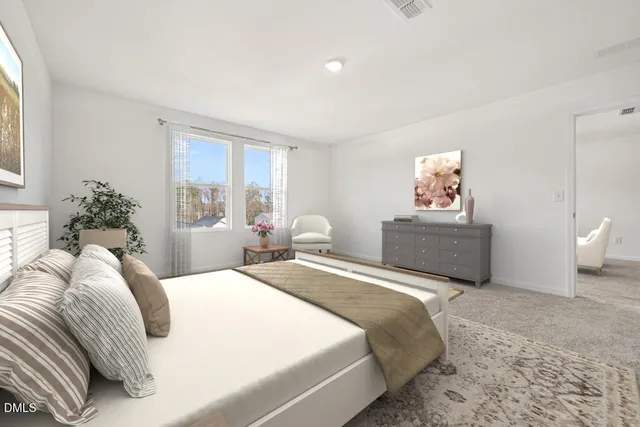 a bedroom with a bed and a painting on the wall