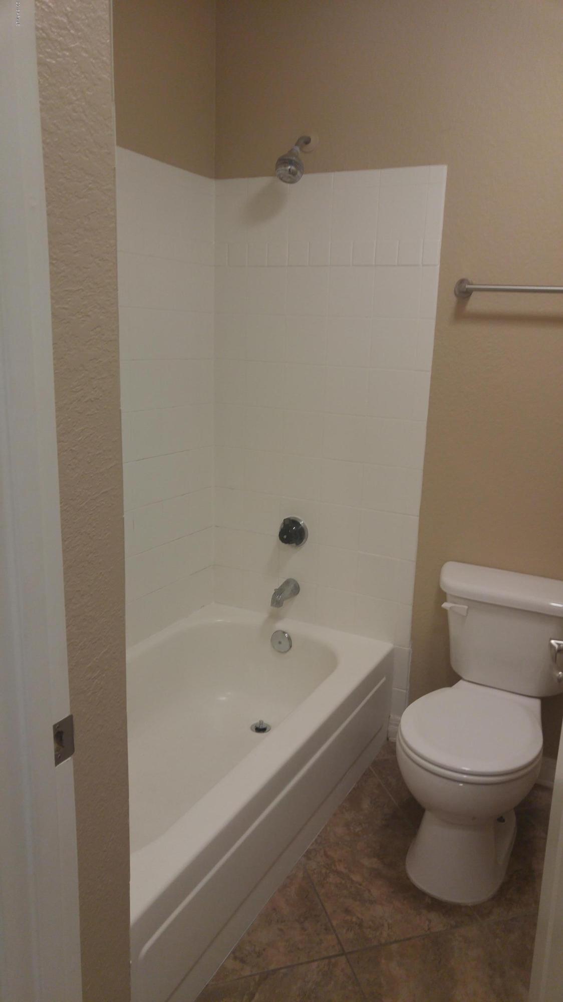 2025 East Campbell Avenue, Unit 341 Phoenix, AZ 85016 - Photo 11 of 20 a white toilet sitting next to a bath tub