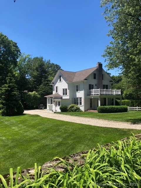 128 5 Mile River Road Darien, CT 06820 - Photo 1 of 23 a front view of a house with a yard