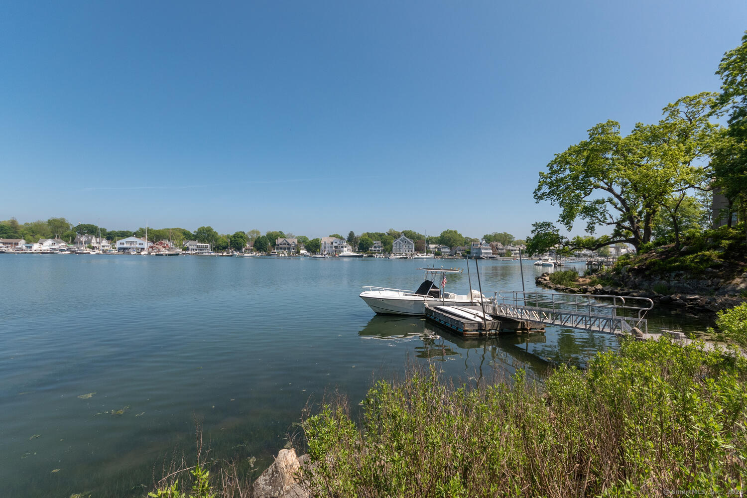 128 5 Mile River Road Darien, CT 06820 - Photo 18 of 23 a view of a lake with houses in the back