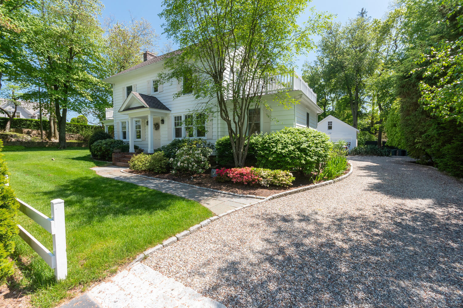 128 5 Mile River Road Darien, CT 06820 - Photo 2 of 23 a front view of a house with garden