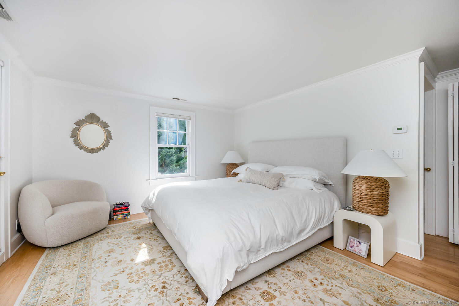 128 5 Mile River Road Darien, CT 06820 - Photo 9 of 23 a bedroom with a bed and a couch