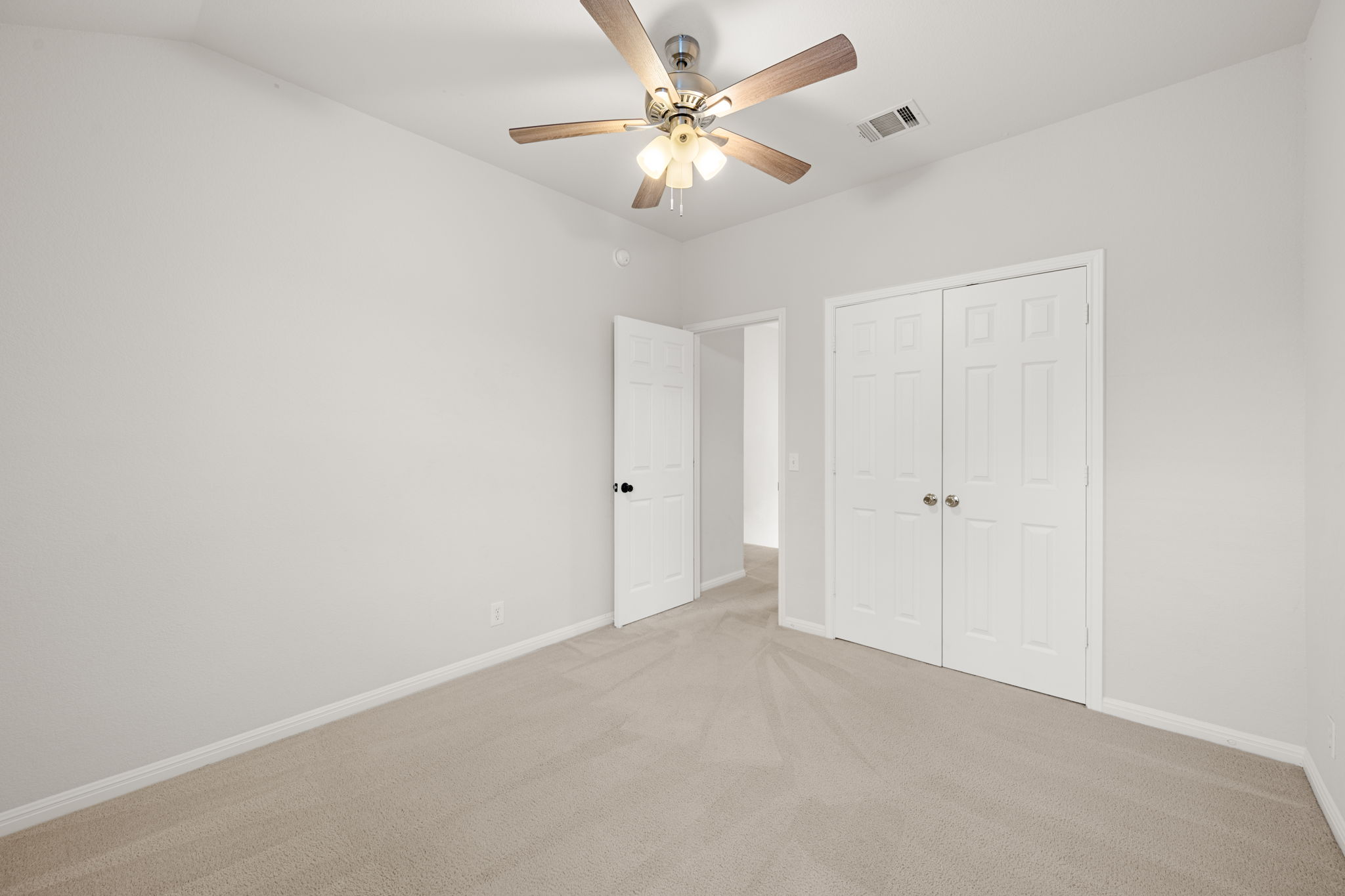 8902 Magna Carta Loop, Unit 122 Austin, TX 78754 - Photo 24 of 39 A spacious, naturally illuminated room featuring plush carpeting and a modern ceiling fan for ultimate comfort.
