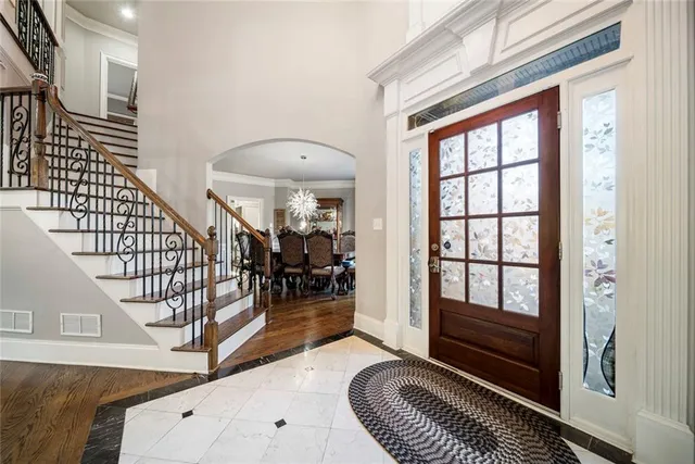 a dining room with furniture a chandelier and wooden floor