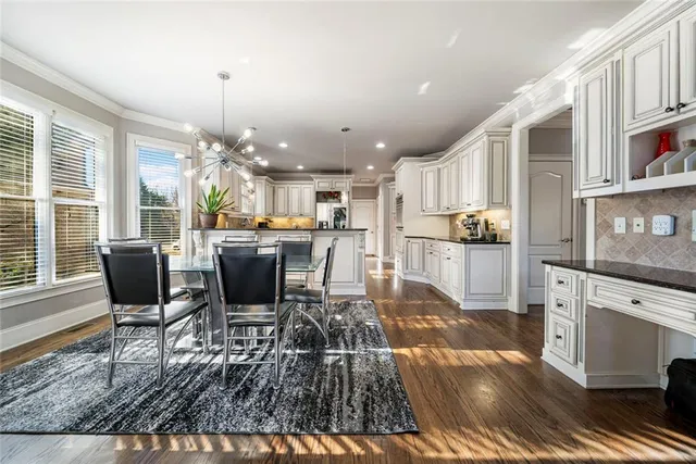 a large kitchen with stainless steel appliances granite countertop a stove and a sink
