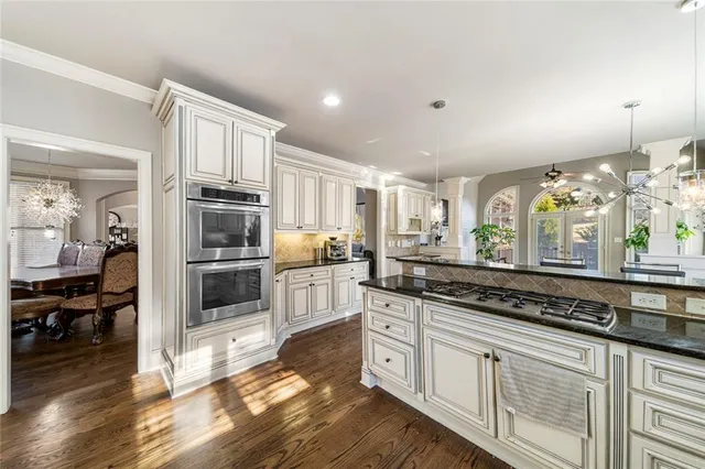 a living room with furniture a fireplace and a potted plant