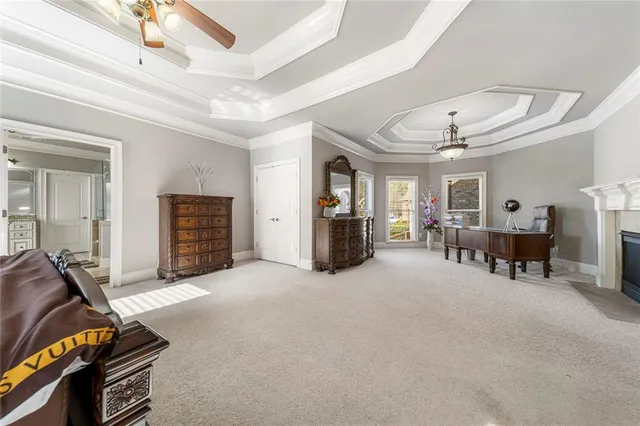 a kitchen with stainless steel appliances kitchen island granite countertop a refrigerator a stove a sink dishwasher and white cabinets with wooden floor