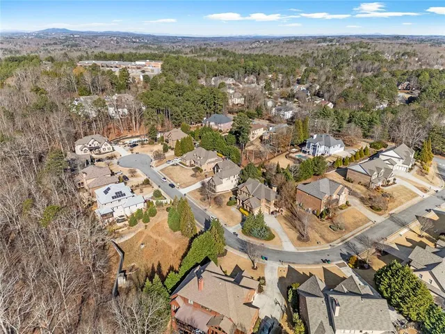 an aerial view of a house with a yard and lake view