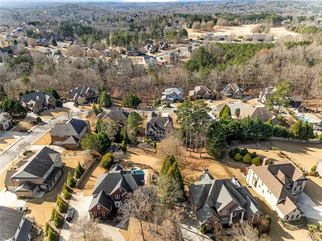 an aerial view of residential houses with outdoor space