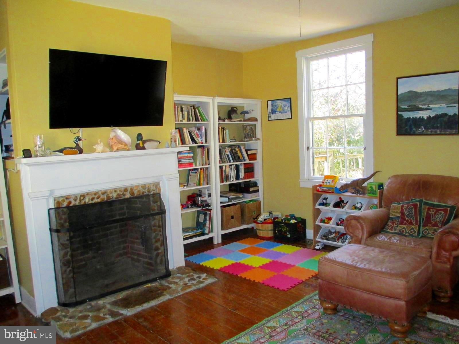 8355 Broad Neck Road Chestertown, MD 21620 - Photo 20 of 33 a living room with furniture a flat screen tv and a fireplace