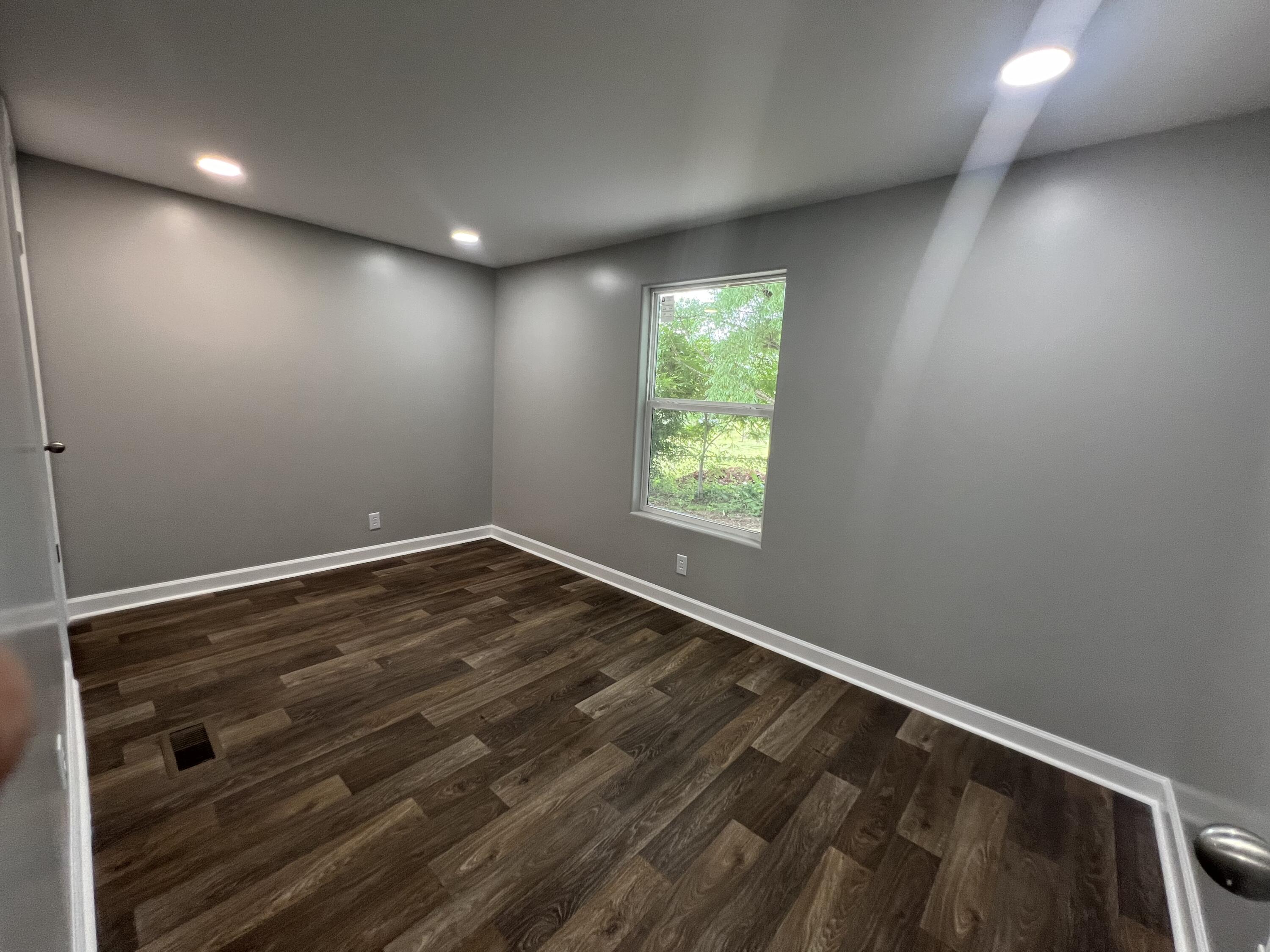 203 Byrnes Street Goodview, VA 24095 - Photo 11 of 13 wooden floor in an empty room