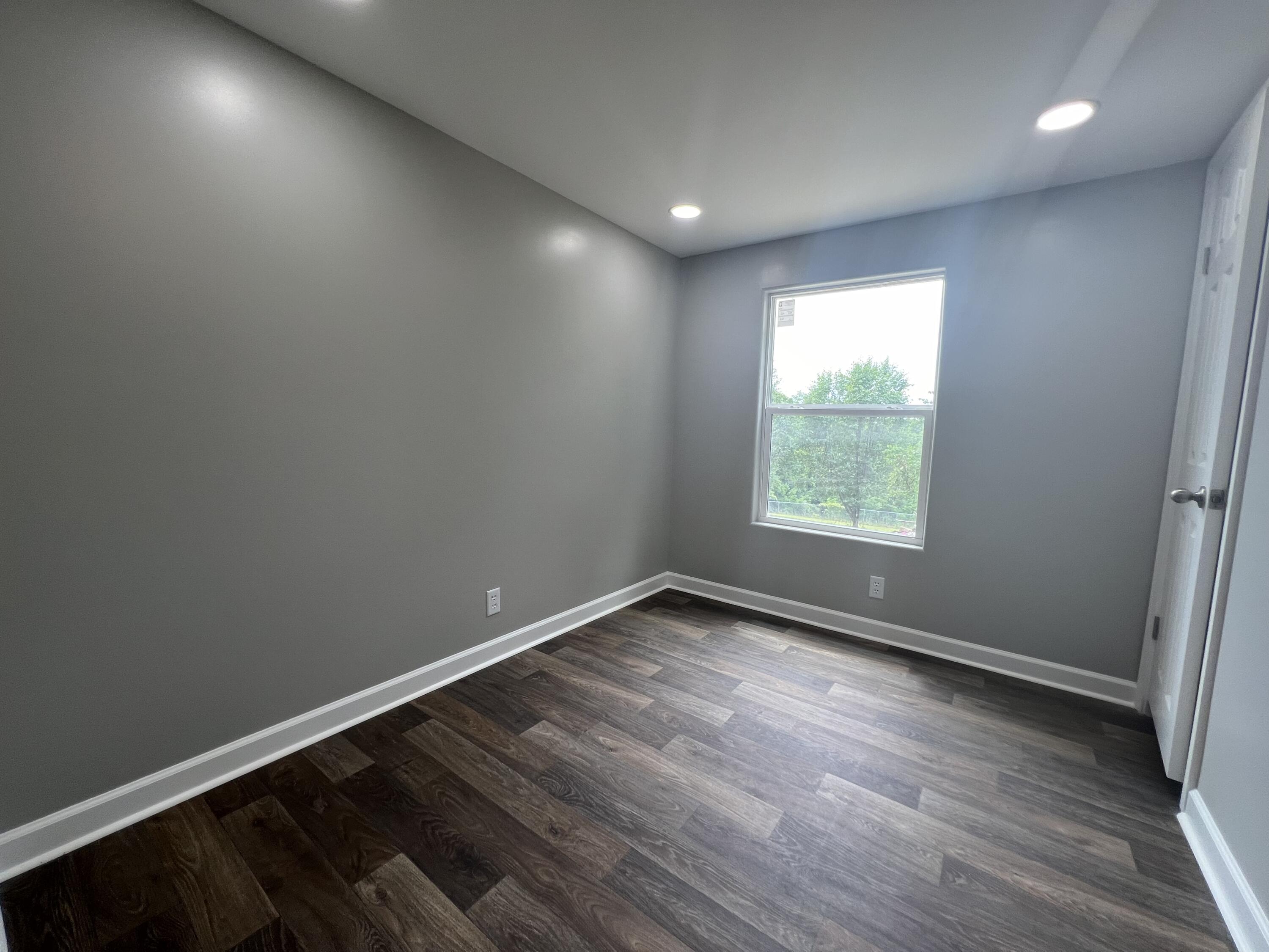 203 Byrnes Street Goodview, VA 24095 - Photo 13 of 13 an empty room with wooden floor and windows