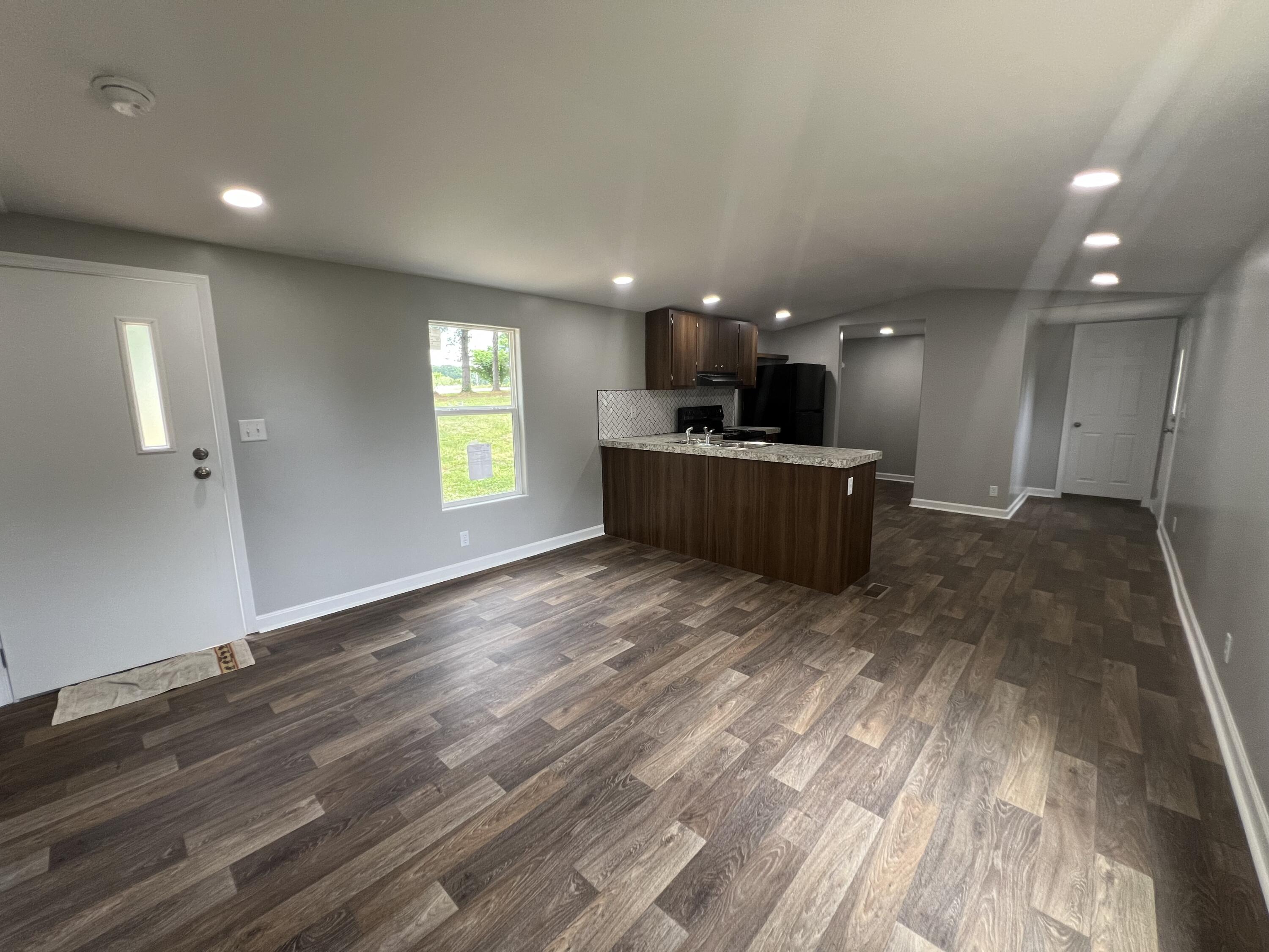 203 Byrnes Street Goodview, VA 24095 - Photo 5 of 13 a view of kitchen and hall with wooden floor