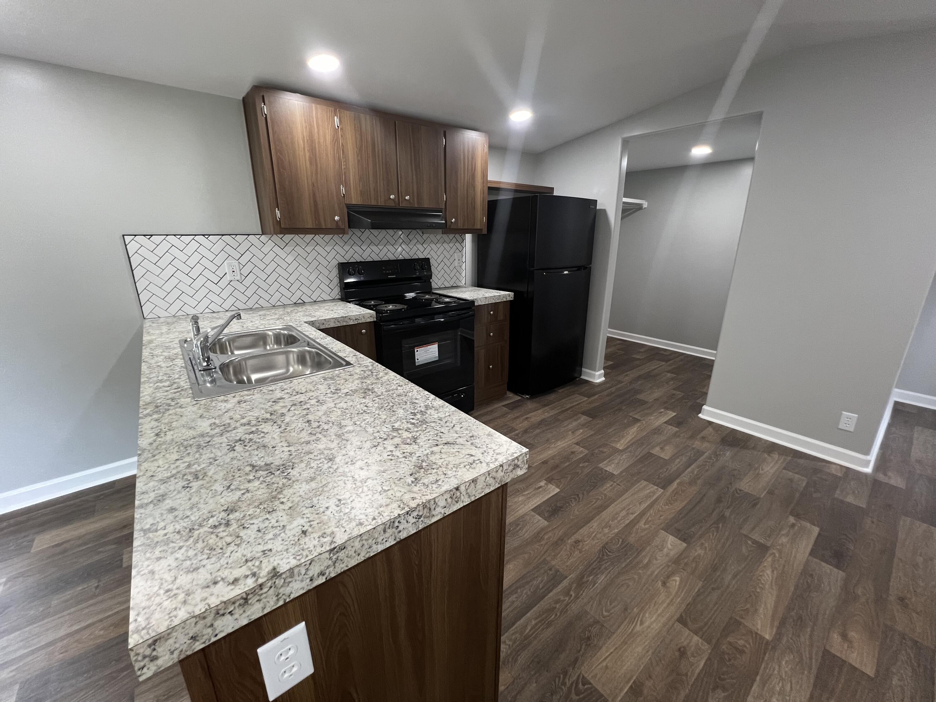 203 Byrnes Street Goodview, VA 24095 - Photo 7 of 13 a kitchen with kitchen island sink refrigerator and stove