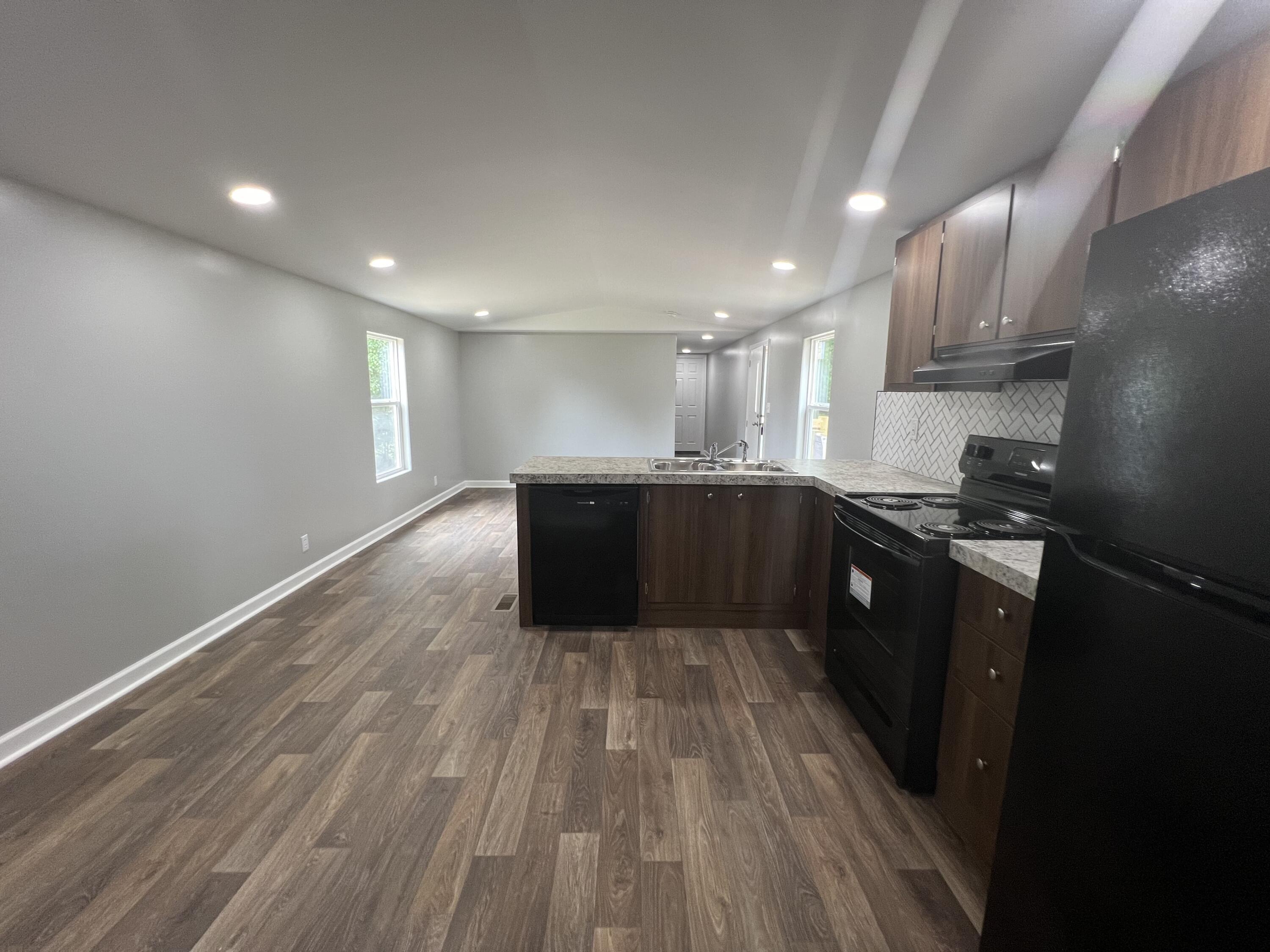 203 Byrnes Street Goodview, VA 24095 - Photo 9 of 13 a large kitchen with wooden floors and stainless steel appliances