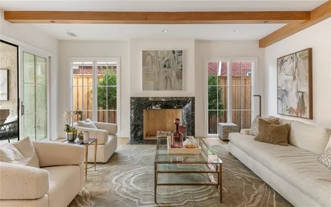 a living room with furniture large window and a fireplace