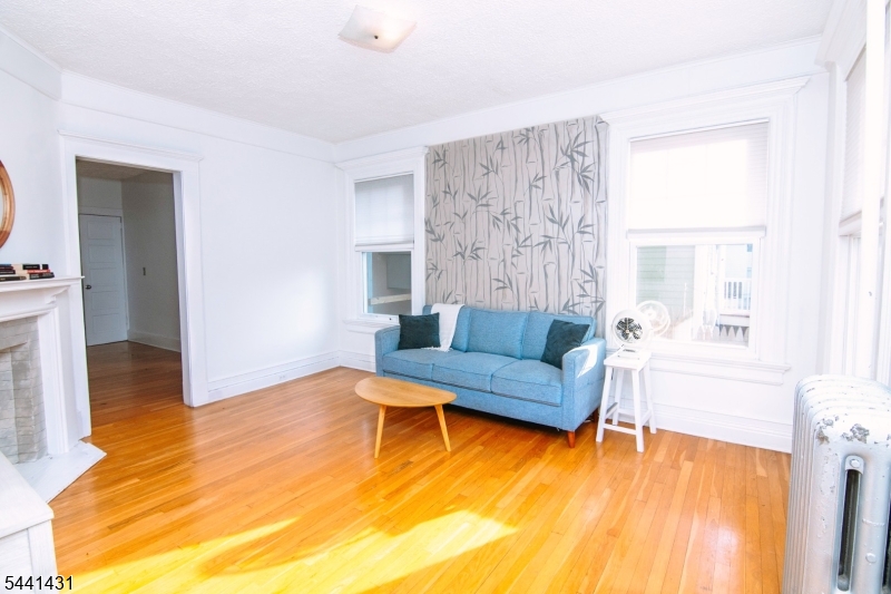 306 Springfield Avenue, Unit 1 Summit, NJ 07901 - Photo 8 of 17 a living room with furniture and a wooden floor