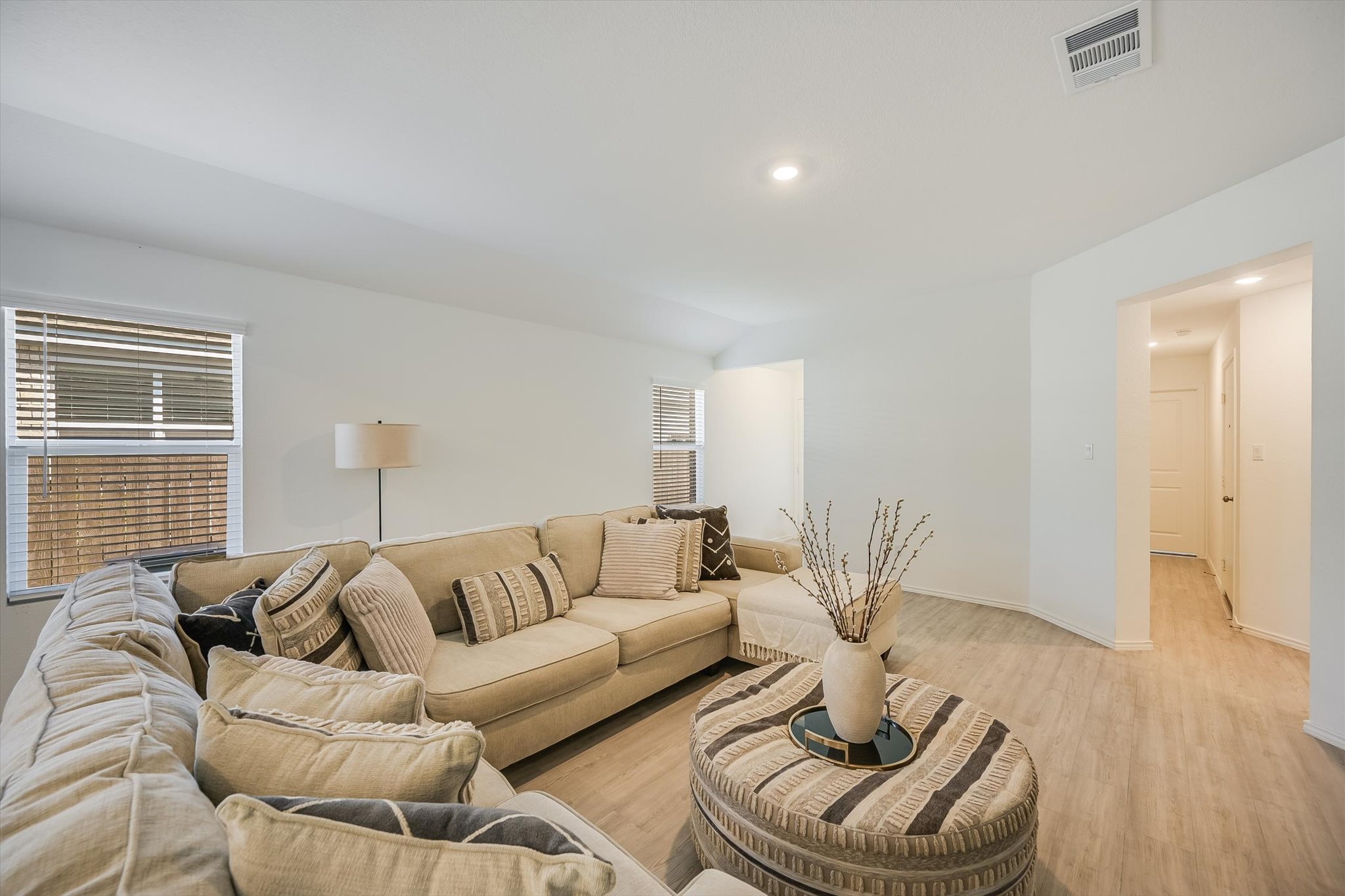 1701 Chapel Ranch Road Georgetown, TX 78628 - Photo 4 of 28 Smooth wood-look flooring and recessed lighting define this comfortable open-plan living area.