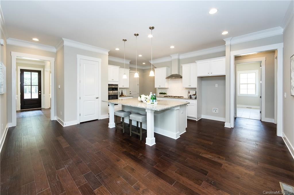 704 Kenway Loop Mooresville, NC 28117 - Photo 11 of 24 a large white kitchen with lots of counter space a sink refrigerator and cabinets
