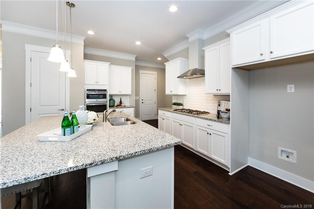 704 Kenway Loop Mooresville, NC 28117 - Photo 12 of 24 a kitchen with sink cabinets and wooden floor