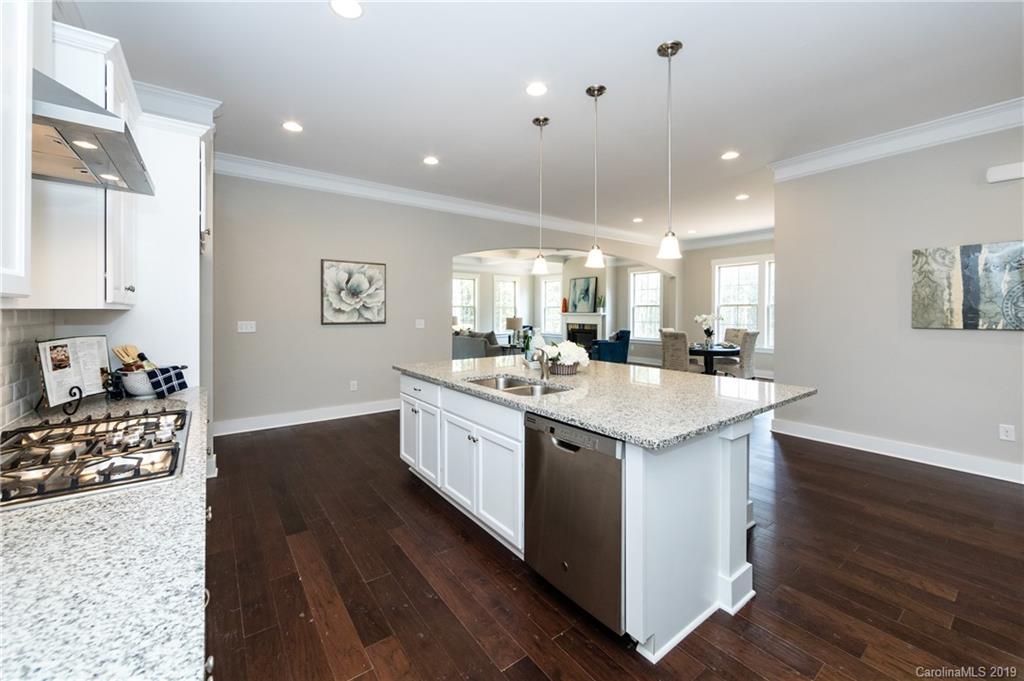 704 Kenway Loop Mooresville, NC 28117 - Photo 14 of 24 a kitchen with granite countertop a sink a counter top space and cabinets