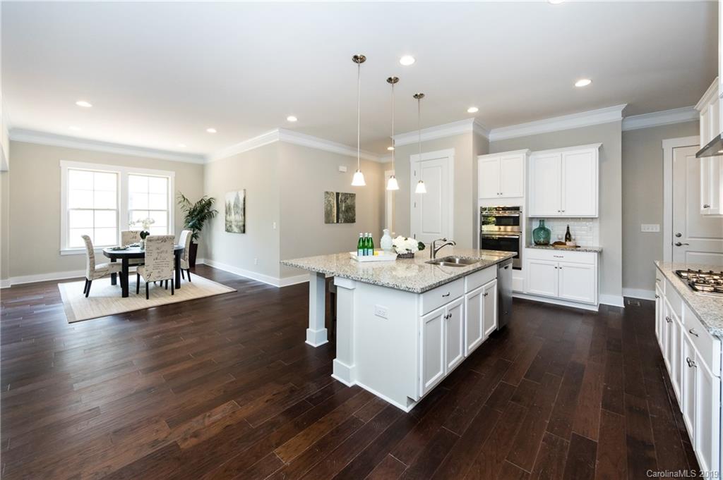 704 Kenway Loop Mooresville, NC 28117 - Photo 15 of 24 a kitchen with stainless steel appliances kitchen island hardwood floor sink and stove