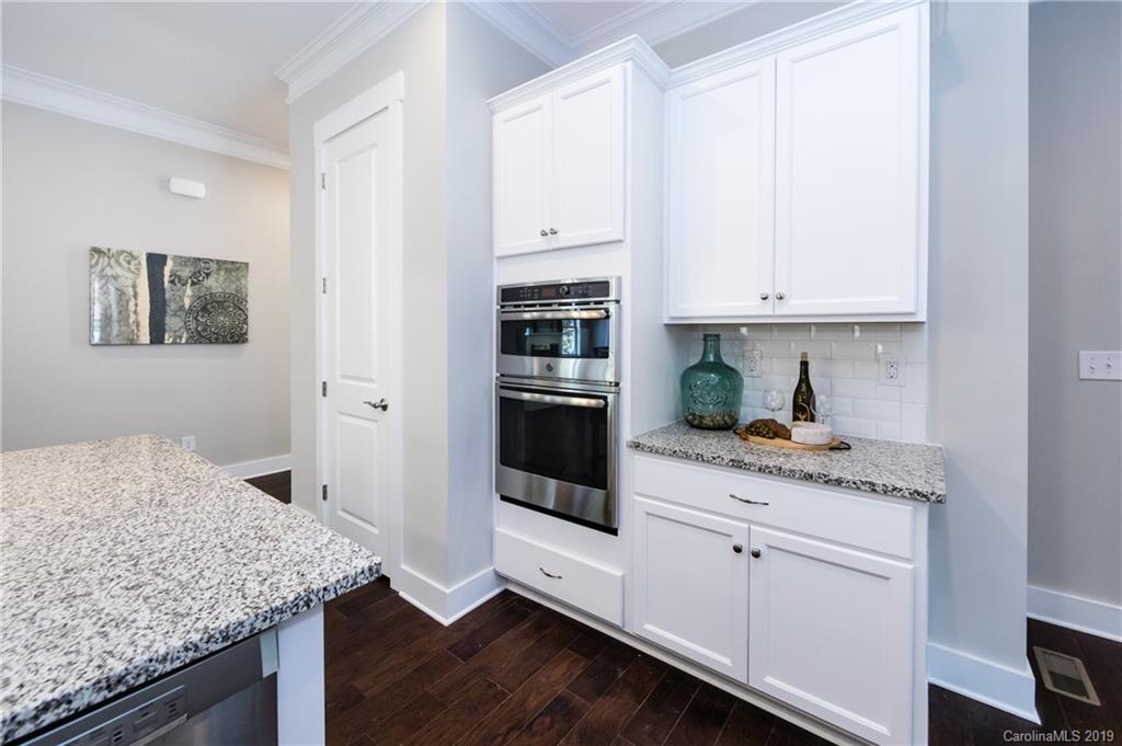 704 Kenway Loop Mooresville, NC 28117 - Photo 16 of 24 a kitchen with stainless steel appliances granite countertop a sink and cabinets