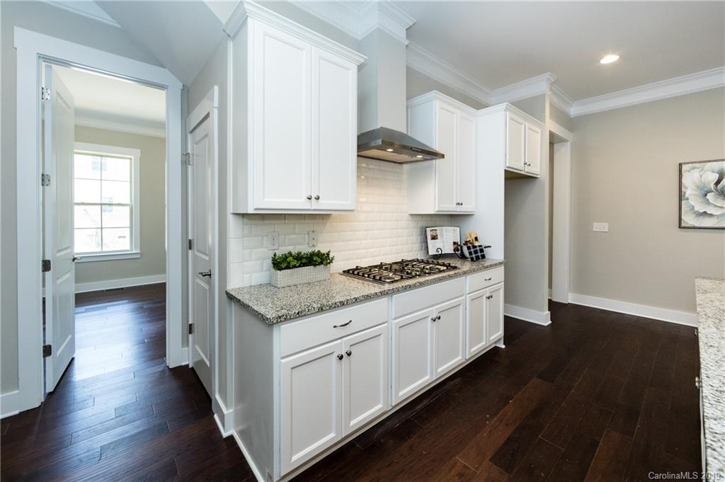 704 Kenway Loop Mooresville, NC 28117 - Photo 17 of 24 a kitchen with stainless steel appliances granite countertop a stove and a sink