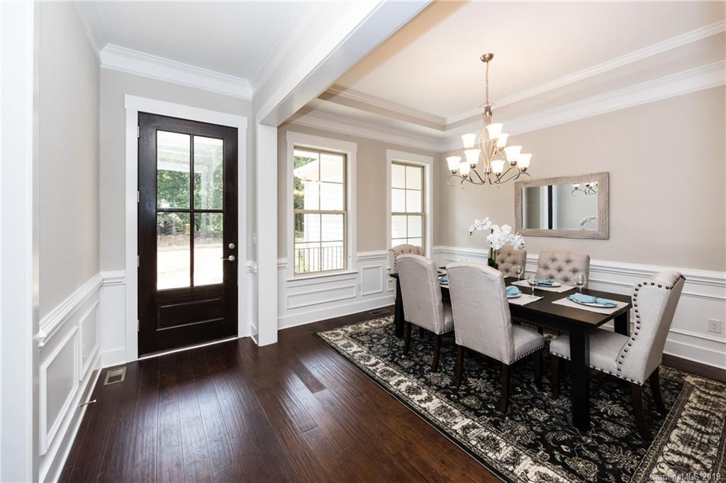 704 Kenway Loop Mooresville, NC 28117 - Photo 5 of 24 a dining room with wooden floor a chandelier a wooden table and chairs