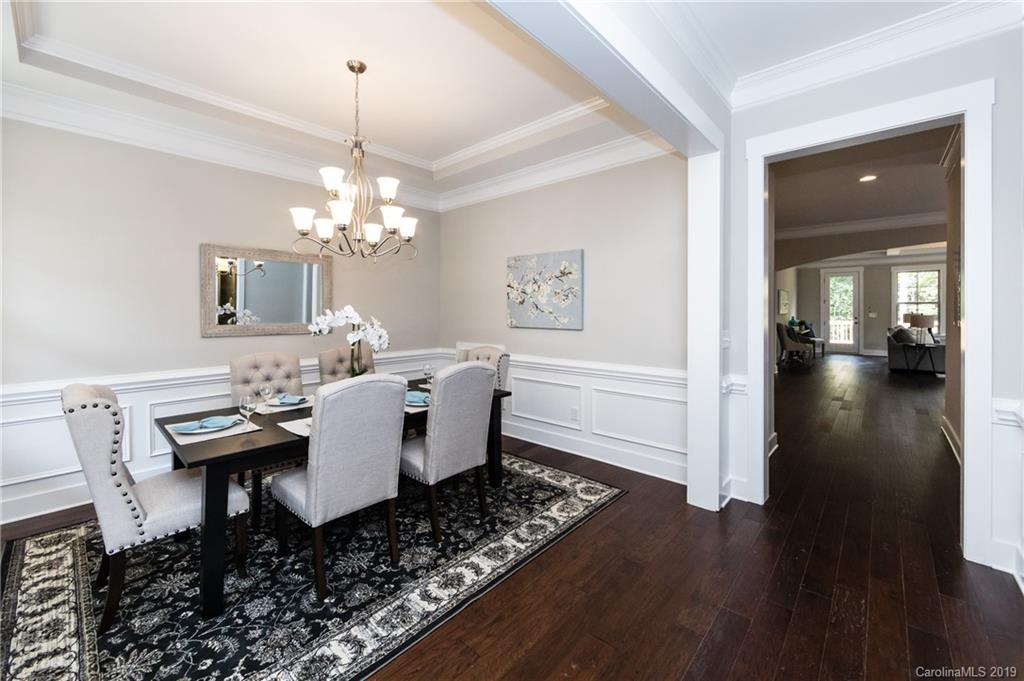 704 Kenway Loop Mooresville, NC 28117 - Photo 6 of 24 a dining room with wooden floor a chandelier a wooden table and chairs
