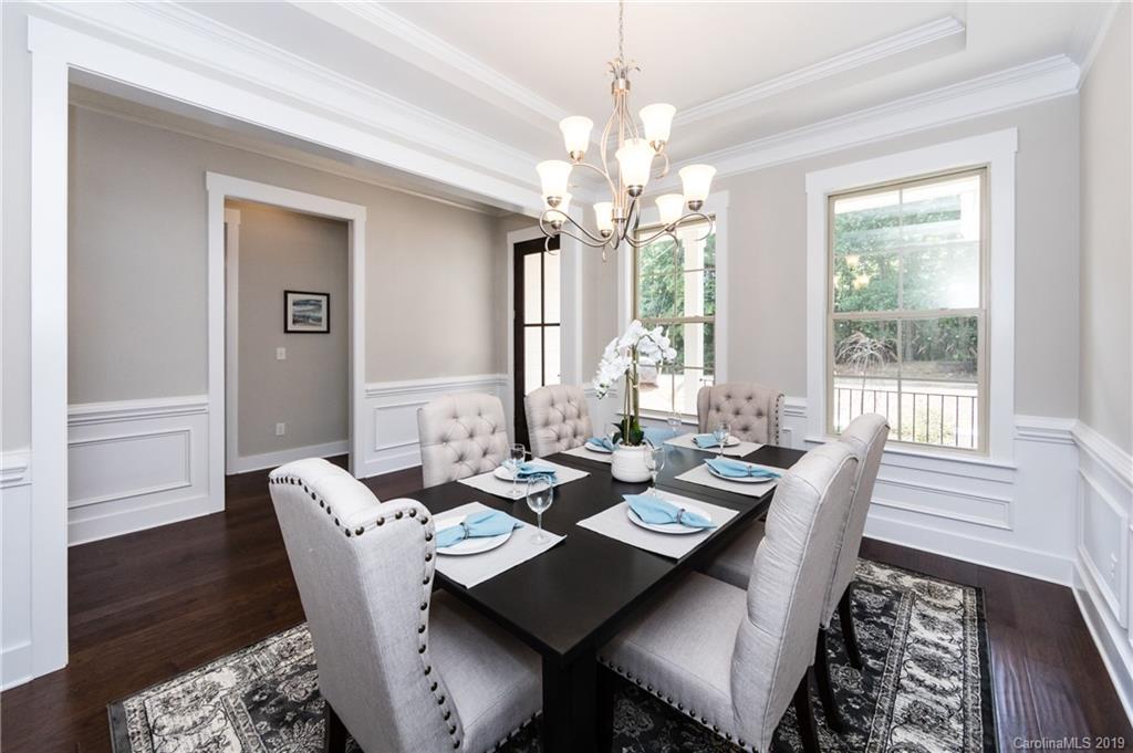 704 Kenway Loop Mooresville, NC 28117 - Photo 7 of 24 a view of a dining room with furniture wooden floor and chandelier