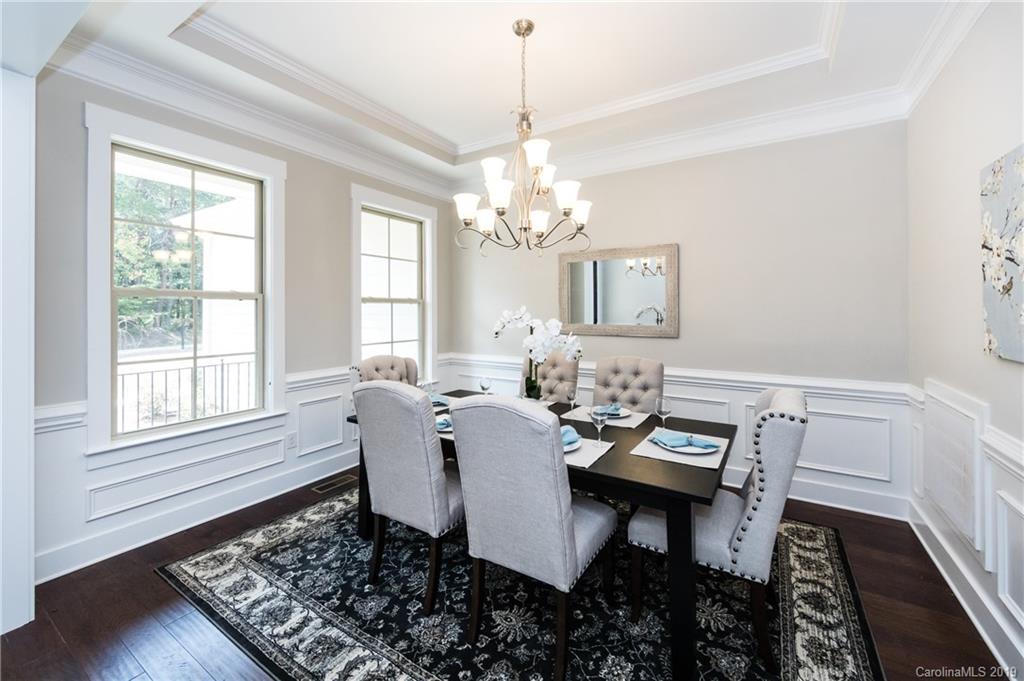 704 Kenway Loop Mooresville, NC 28117 - Photo 8 of 24 a dining room with wooden floor a chandelier a wooden table and chairs