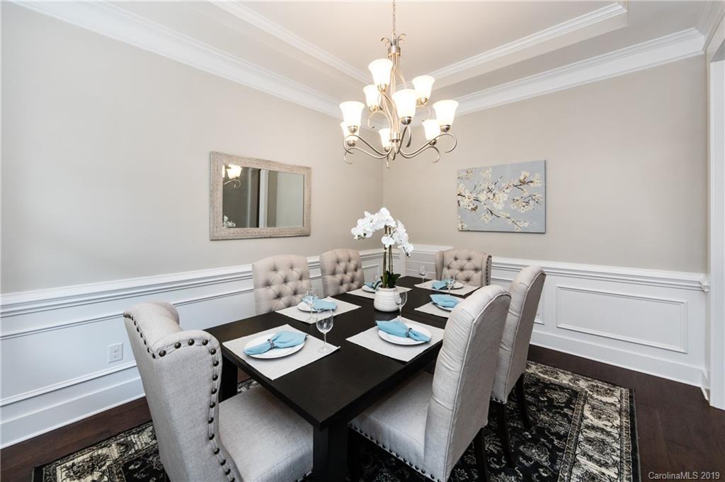 704 Kenway Loop Mooresville, NC 28117 - Photo 9 of 24 a view of a dining room with furniture a chandelier and wooden floor