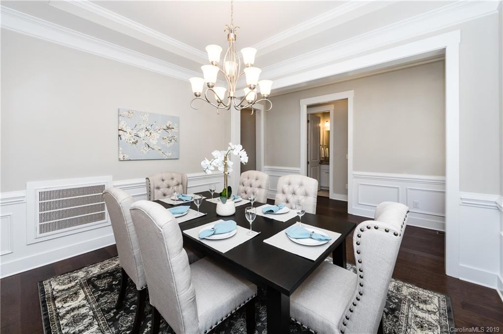 704 Kenway Loop Mooresville, NC 28117 - Photo 10 of 24 a view of a dining room with furniture wooden floor and a chandelier
