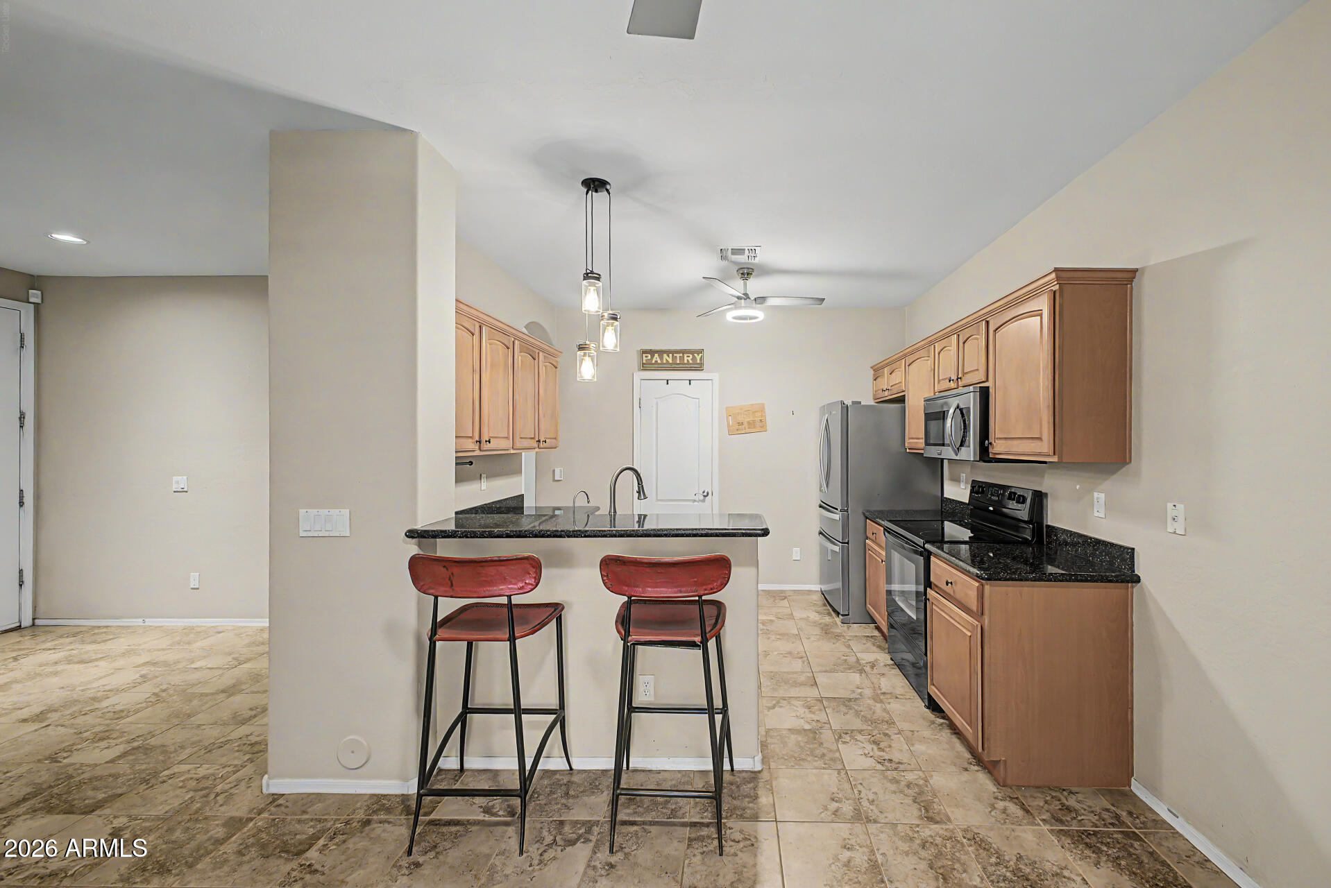 2600 East Springfield Place, Unit 109 Chandler, AZ 85286 - Photo 10 of 38 a kitchen with stainless steel appliances a sink stove and cabinets