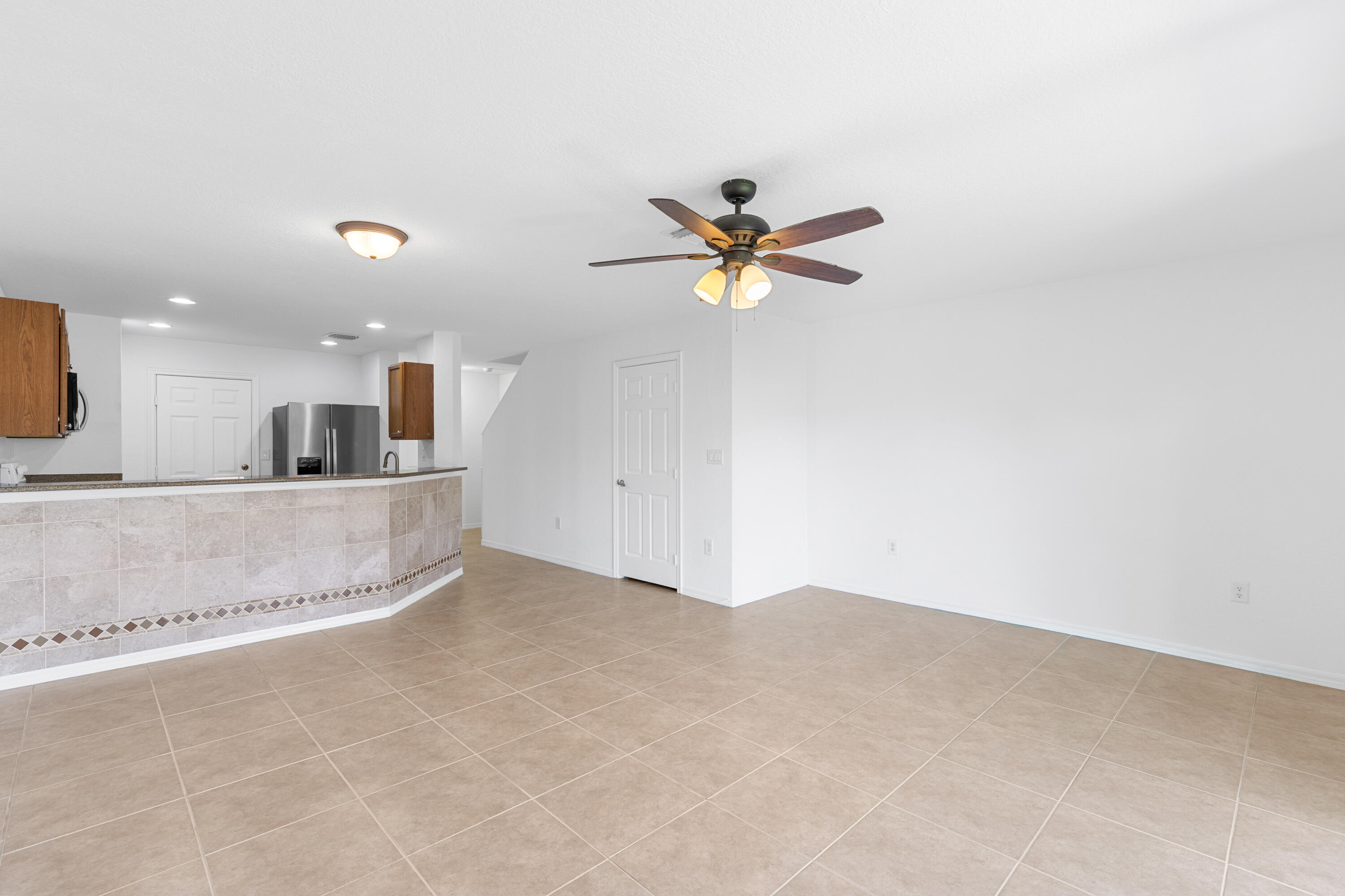 9107 Chambers Street, Unit 9107 Tamarac, FL 33321 - Photo 8 of 30 a view of a kitchen with a sink and a chandelier
