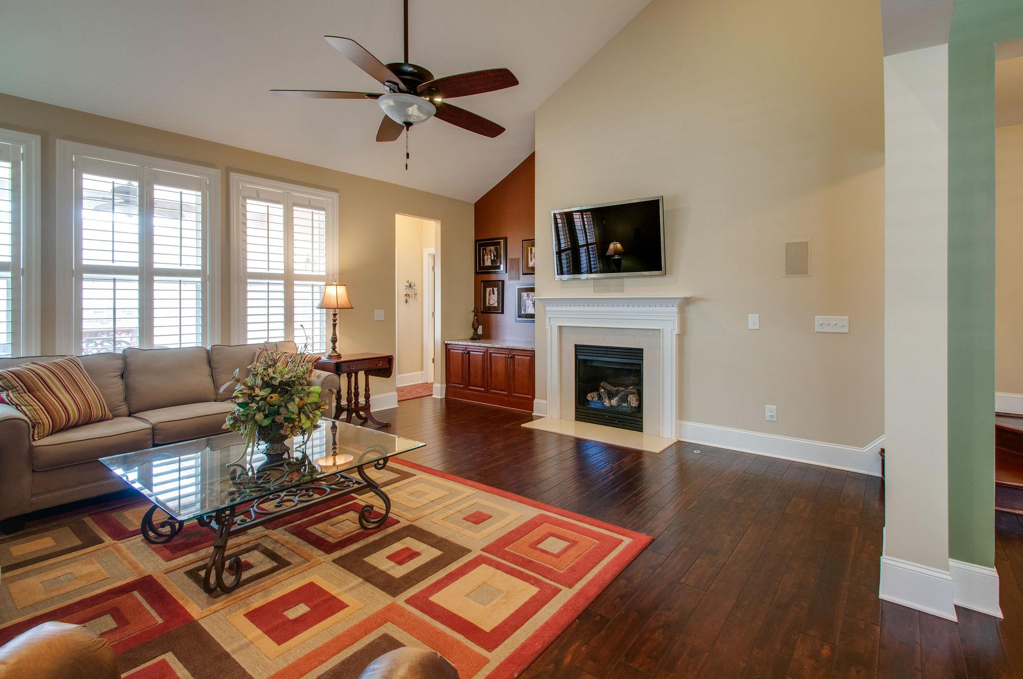 511 Phillips Drive Franklin, TN 37067 - Photo 14 of 29 a living room with furniture a flat screen tv and a fireplace