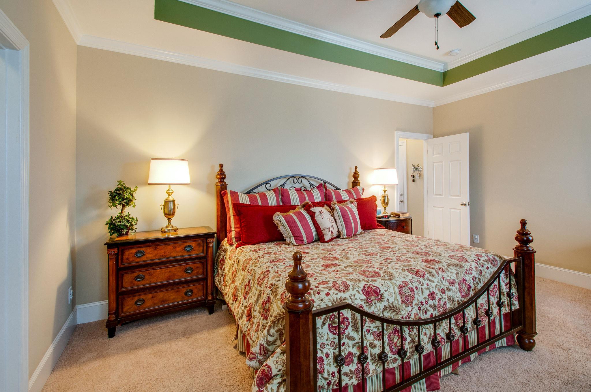 511 Phillips Drive Franklin, TN 37067 - Photo 17 of 29 a bedroom with a bed and a chandelier