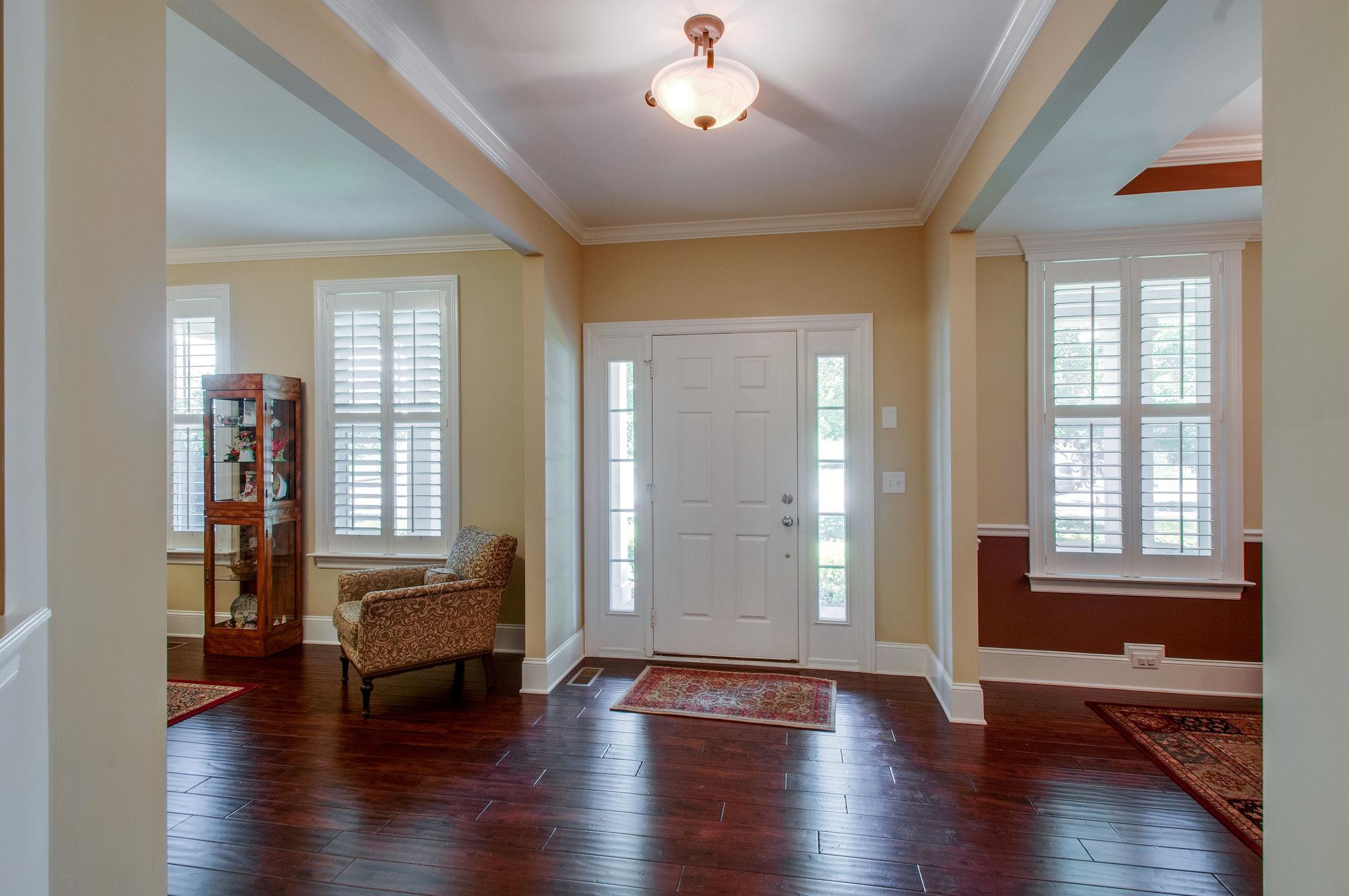 511 Phillips Drive Franklin, TN 37067 - Photo 4 of 29 an empty room with wooden floor and windows