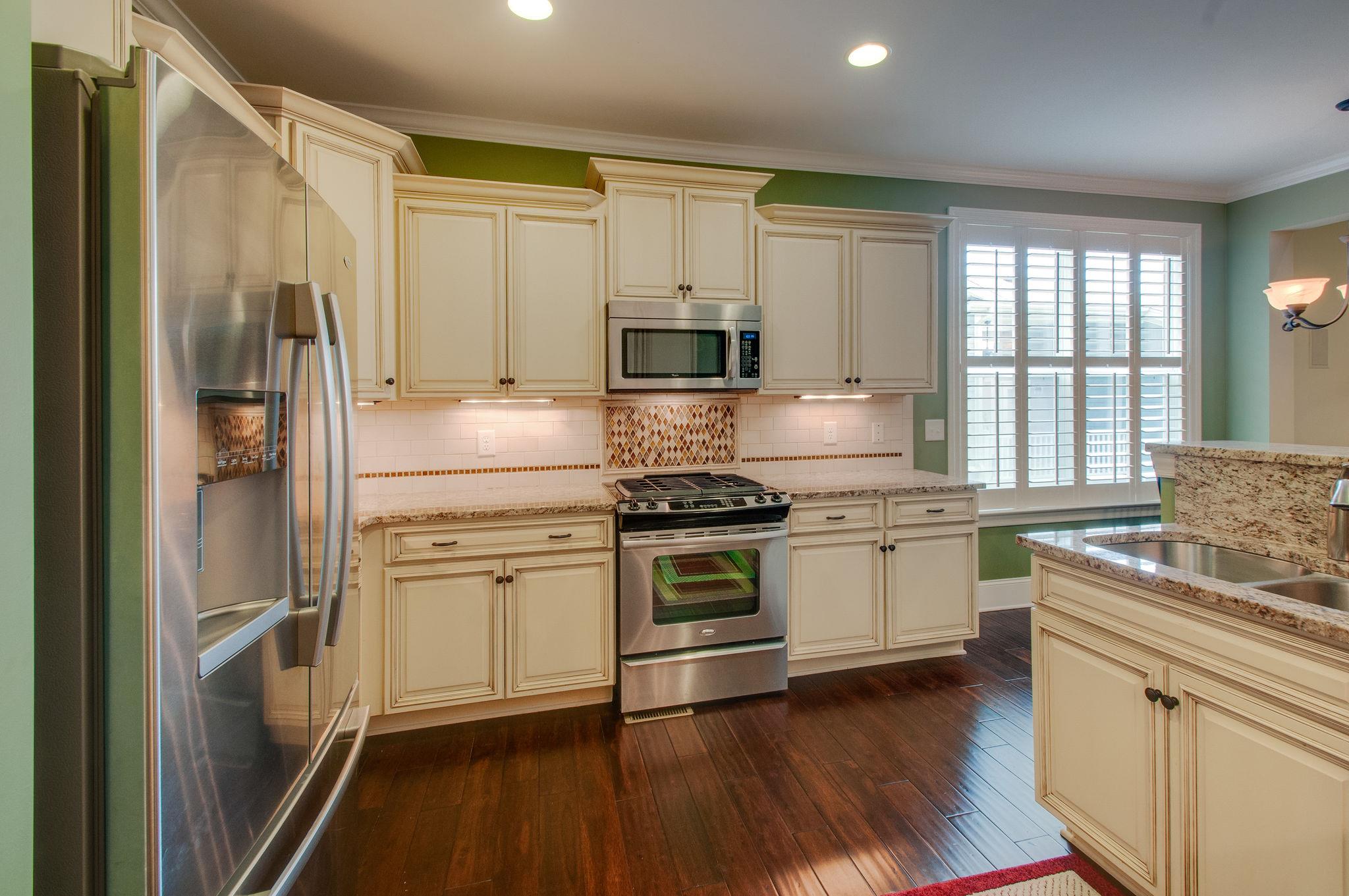 511 Phillips Drive Franklin, TN 37067 - Photo 9 of 29 a kitchen with stainless steel appliances a stove sink and refrigerator