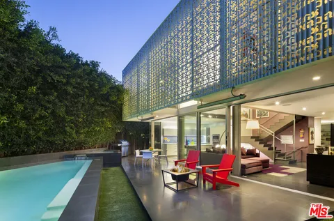 a swimming pool with outdoor seating and yard