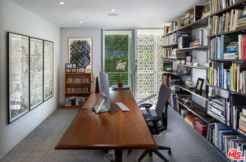 a bedroom with furniture and a book shelf
