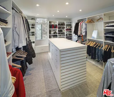 a livingroom with workspace a couch and a window