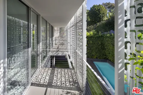 a living room with furniture flowerpot and wooden floor