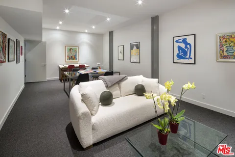 a living room with furniture and a rug