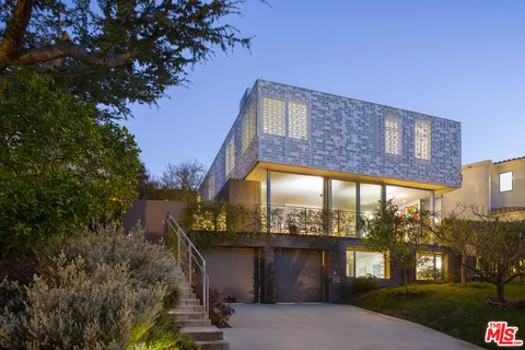 a view of a brick building next to a yard