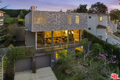 a view of a patio with table and chairs and potted plants