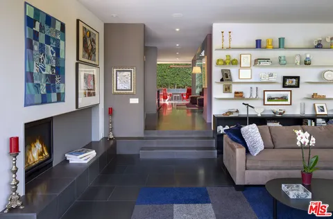 a living room with furniture and a floor to ceiling window