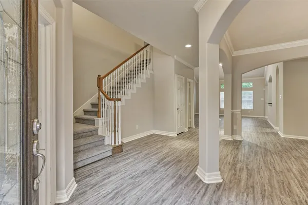 a view of entryway with wooden floor and staircase